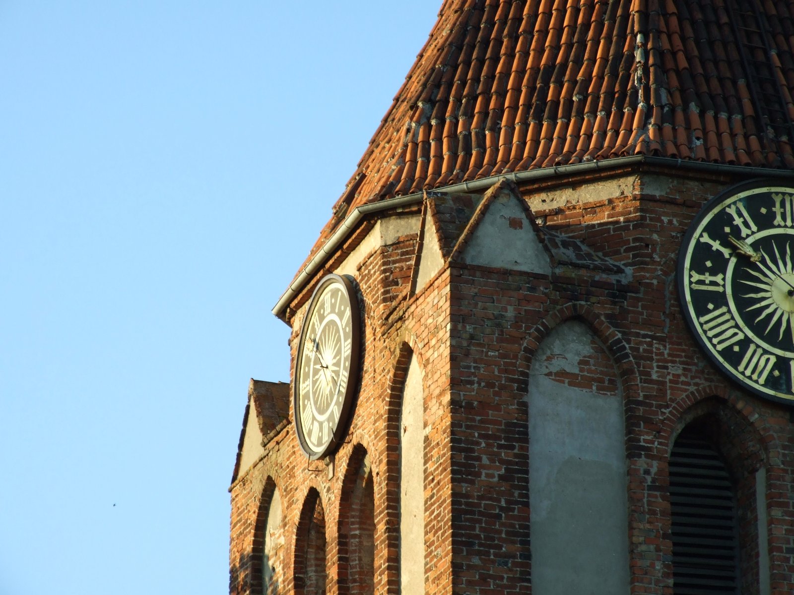 Closeup view of st. Cross church tower in Pruszcz Gdański, Pomeranian voivodeship, Poland | Pruszcz Gdański in Poland