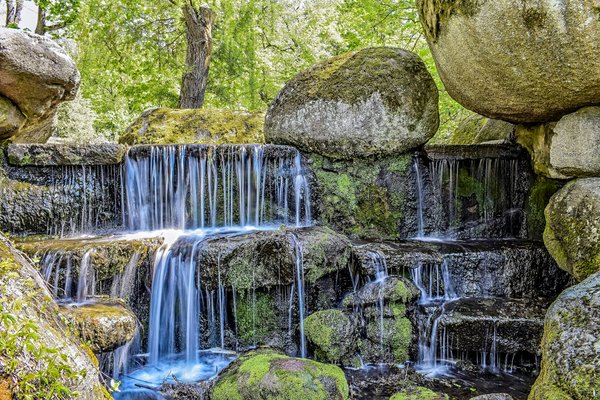Spring. Park. Trees and reservoirs. The river flows and flows through the rocks a cascading waterfall. | Uman in Ukraine