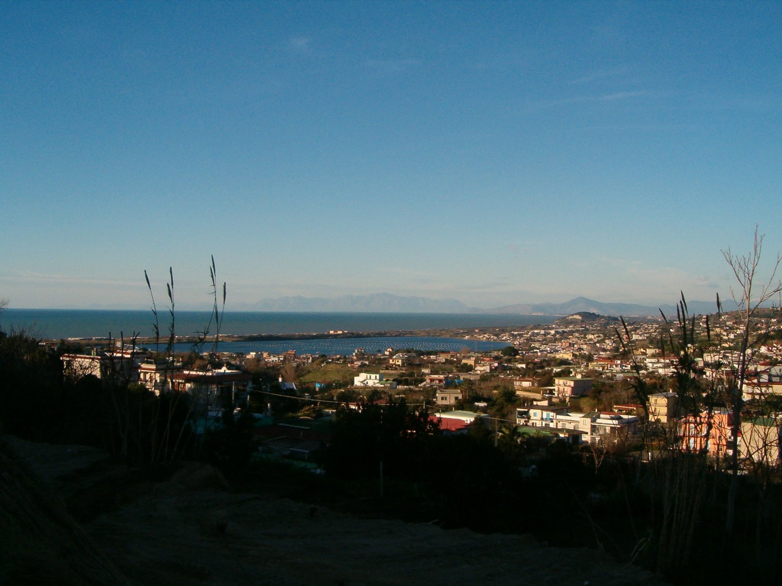 Comune di Bacoli: frazione di Cappella e di Fusaro, con il Lago Fusaro e in fondo la piccola collina dell'acropoli di Cuma. | Bacoli in Italy
