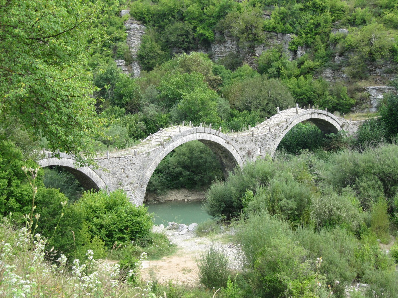 Bridge near the village of Kipoi, known as Plakida's or Kalokeriko (monk's) bridge; famous stone arch bridge in Vikos-Aoos National Park, Ioannina Prefecture, NW Greece | Kipoi in Greece