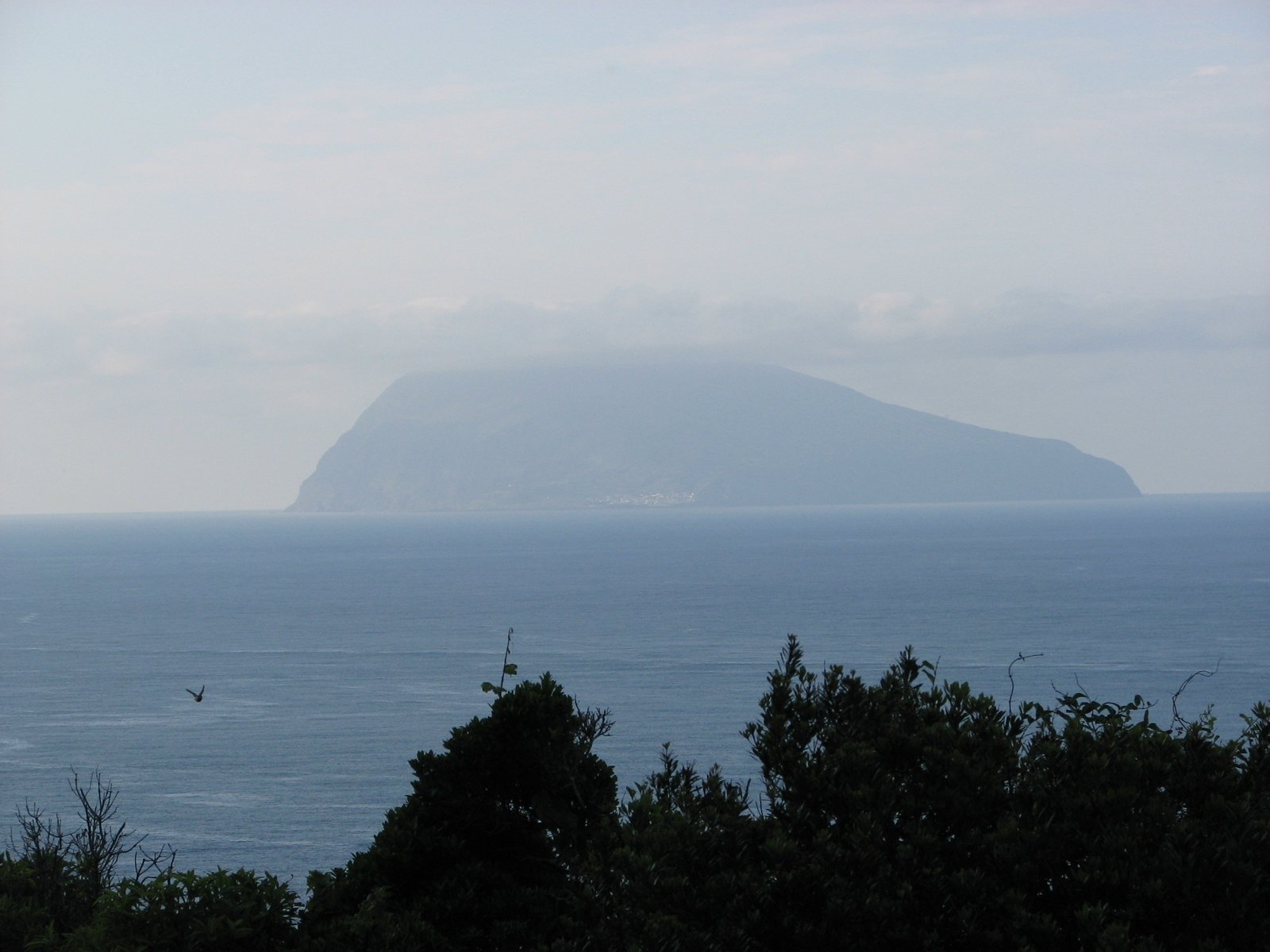 The island of Corvo seen from the northeastern coast of Flores, Azores. | Ilha do Corvo in Portugal