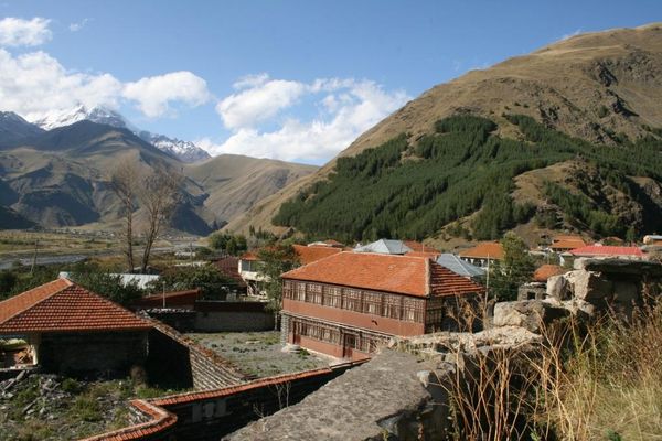 Old houses in the village of Sno, Georgia, with Mt. Kazbek in the left background. View from the Sno fortress. | Sno in Georgia