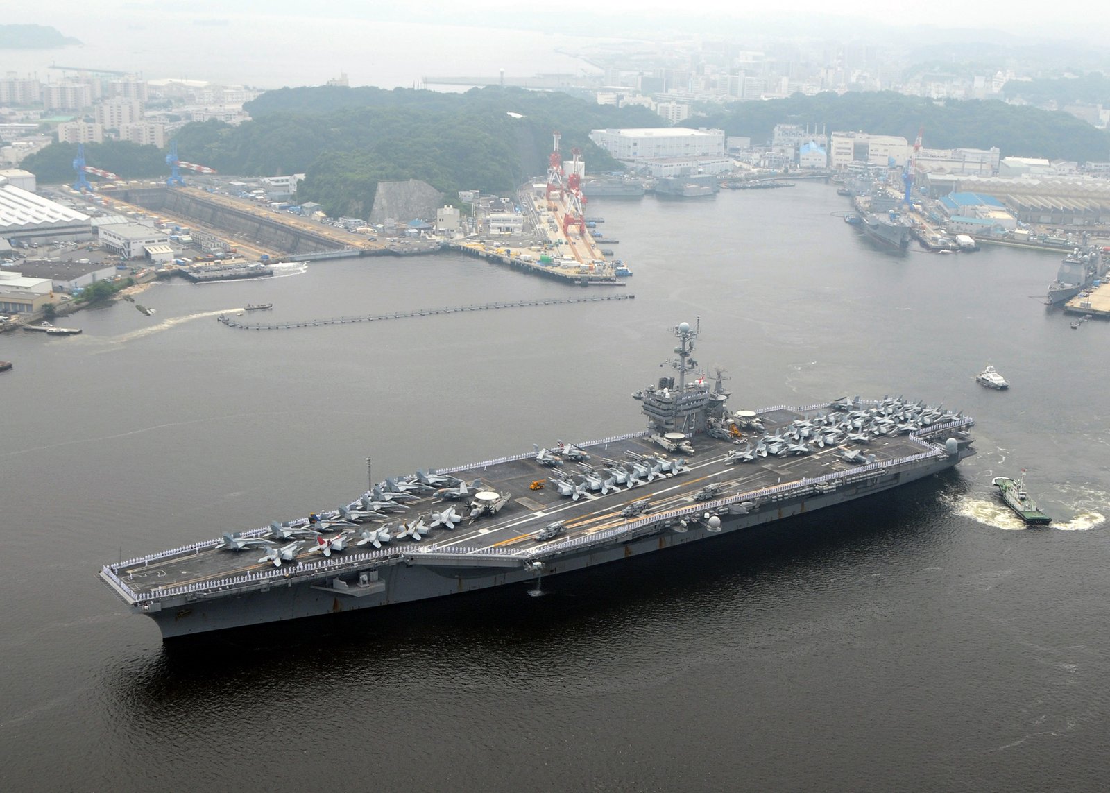 YOKOSUKA, Japan (June 10, 2009) Sailors man the rails aboard the aircraft carrier USS George Washington (CVN 73) as the ship departs on her first summer deployment since arriving at Fleet Activities Yokosuka, Japan. George Washington is underway supporting security and stability in the western Pacific Ocean. (U.S. Navy photo by Mass Communication Specialist 2nd Class Clifford L. H. Davis/Released) | Yokosuka in Japan