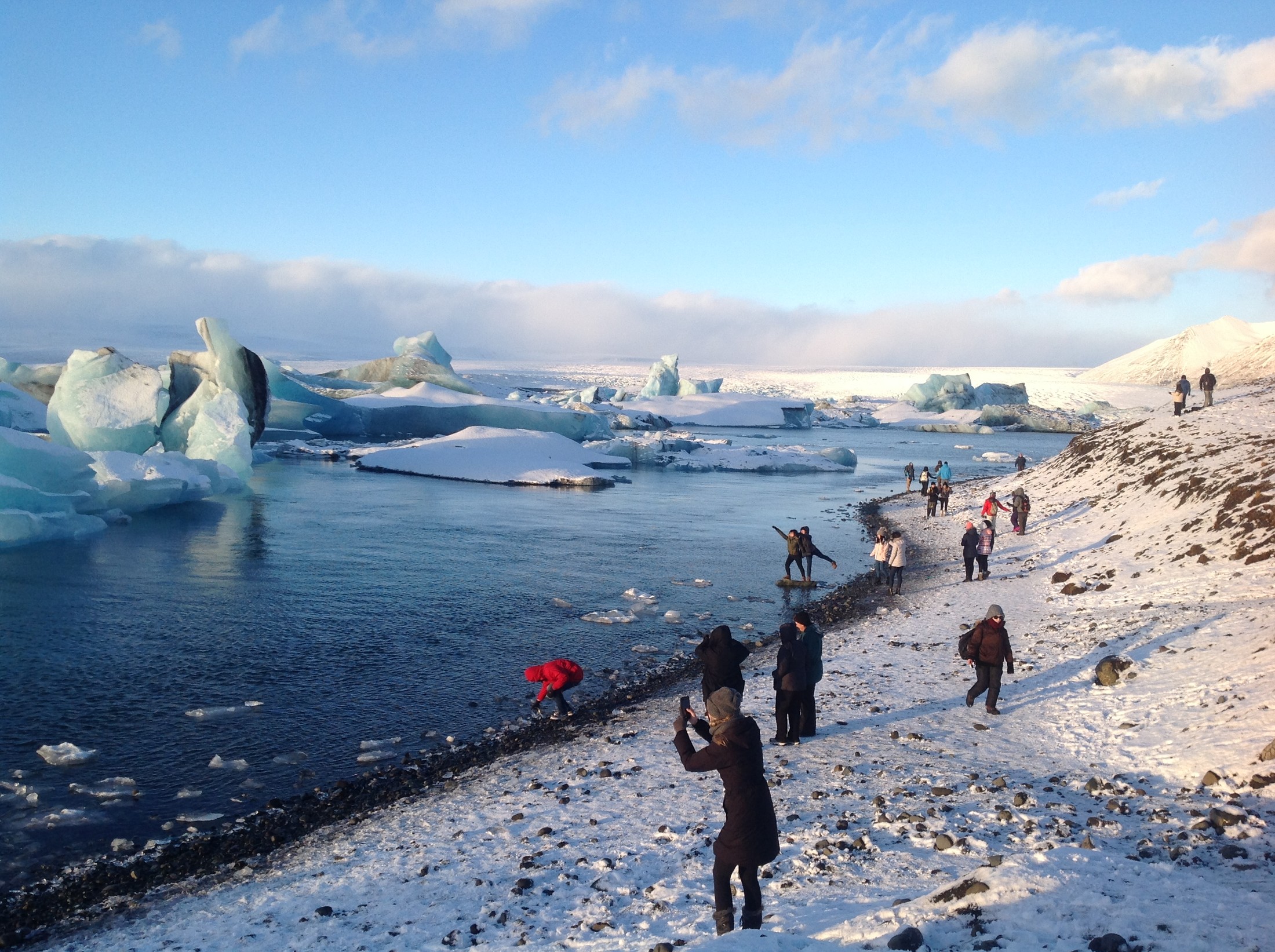 Tourists explore the glacial lagoon of Jökulsárlón in January of 2017. | Diamond Beach in Iceland